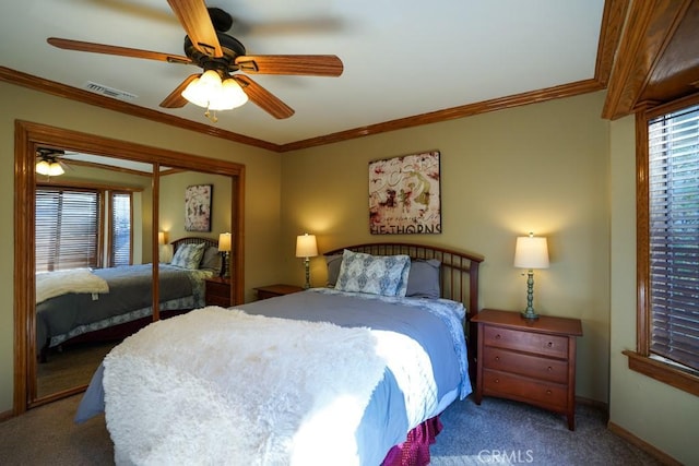 carpeted bedroom featuring ceiling fan, a closet, and ornamental molding