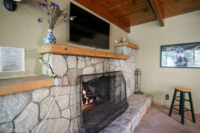 room details featuring carpet flooring, wooden ceiling, a stone fireplace, and beamed ceiling