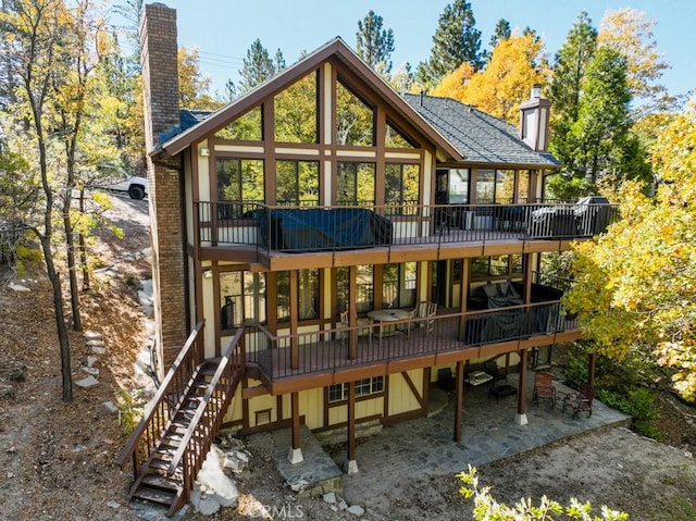 rear view of house featuring a patio and a deck