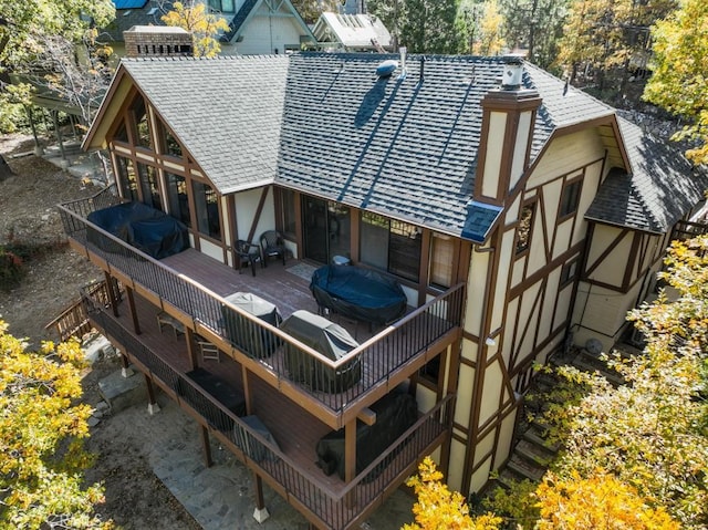 rear view of house with a wooden deck