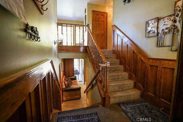 stairway featuring a wealth of natural light and tile patterned flooring