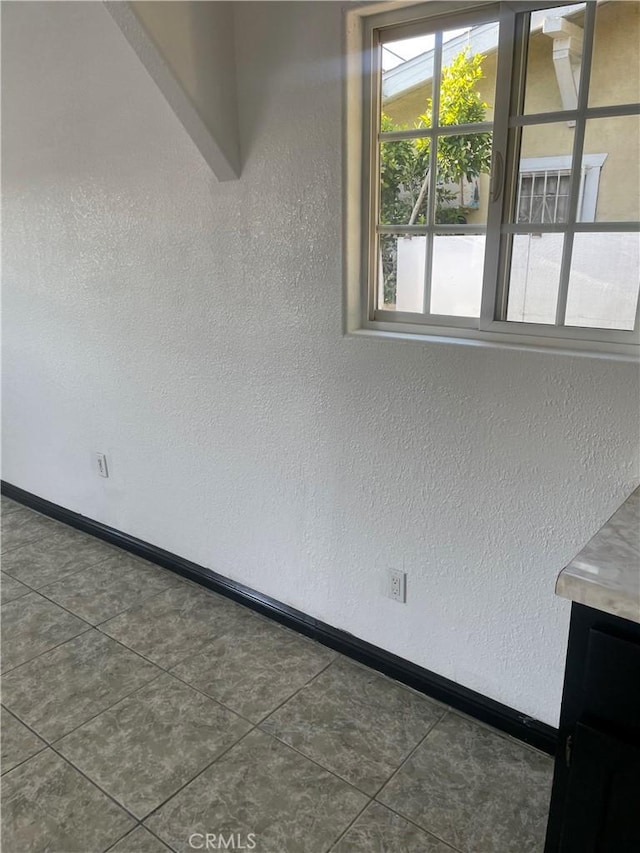 empty room featuring dark tile patterned flooring