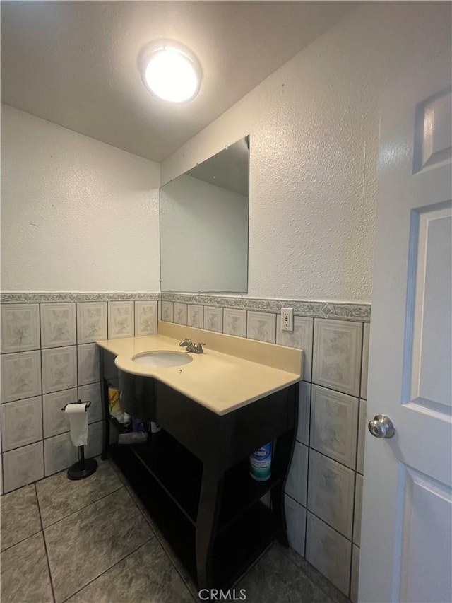 bathroom with vanity, tile patterned floors, and tile walls