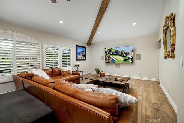 living room with lofted ceiling with beams and light hardwood / wood-style flooring