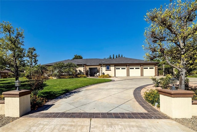 view of front of house with a garage and a front lawn