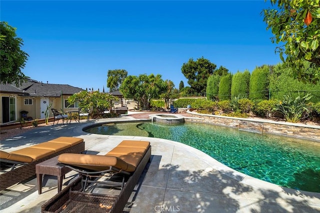 view of pool with an in ground hot tub and a patio