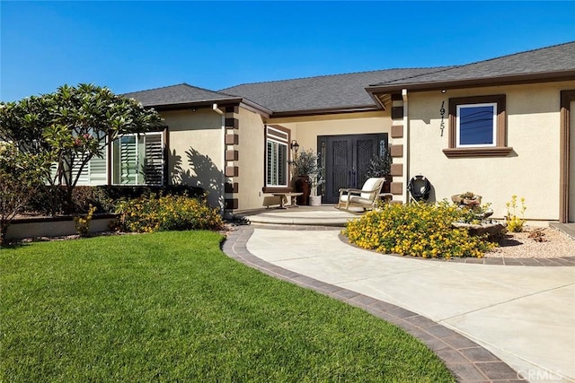 property entrance with a yard