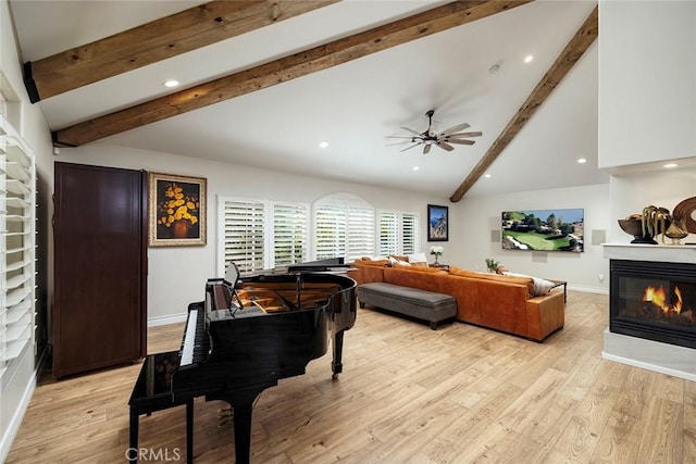 living room with lofted ceiling with beams, light hardwood / wood-style floors, and ceiling fan