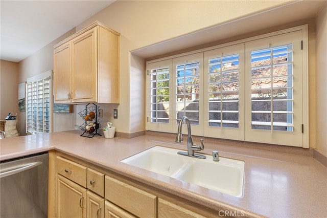 kitchen featuring dishwasher, light brown cabinets, and sink