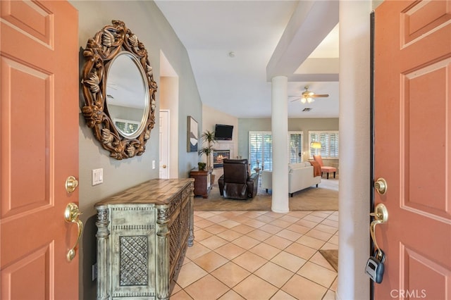 entrance foyer with ceiling fan and light tile patterned flooring