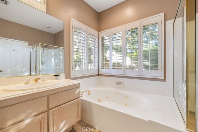 bathroom featuring separate shower and tub, tile patterned floors, and vanity