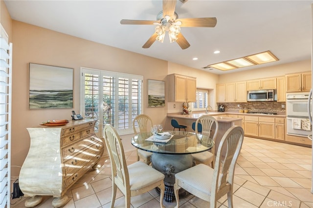 dining space featuring ceiling fan and light tile patterned flooring