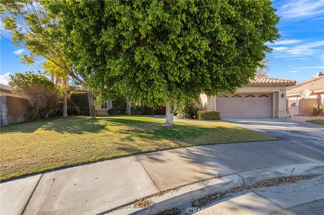 view of property hidden behind natural elements featuring a front yard and a garage