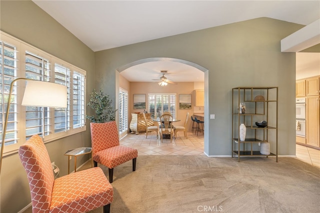 sitting room with light carpet, ceiling fan, and lofted ceiling