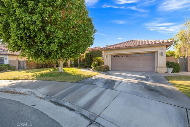 view of front of property with a garage and a front lawn