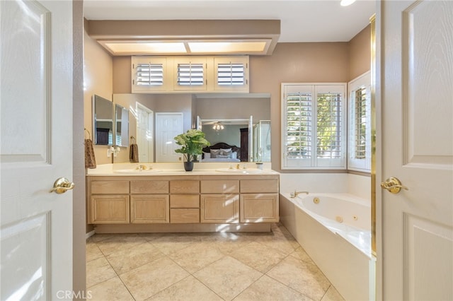 bathroom with tile patterned floors, vanity, and a tub to relax in