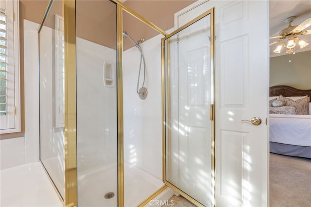 bathroom featuring ceiling fan and an enclosed shower