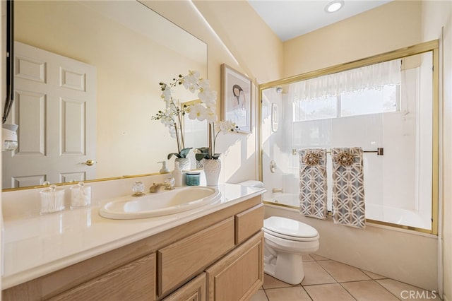 full bathroom featuring tile patterned floors, vanity, toilet, and bath / shower combo with glass door