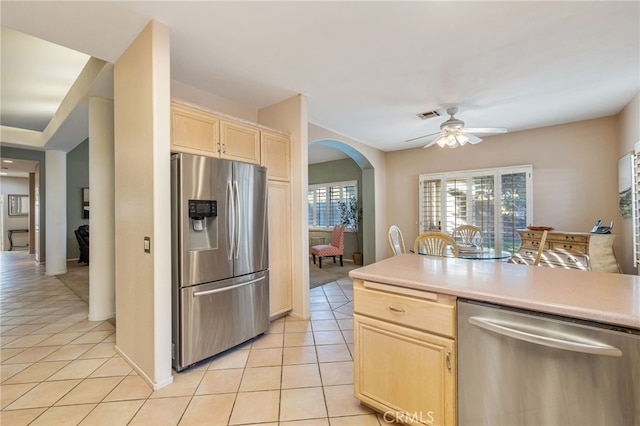 kitchen with ceiling fan, light brown cabinetry, light tile patterned flooring, and appliances with stainless steel finishes