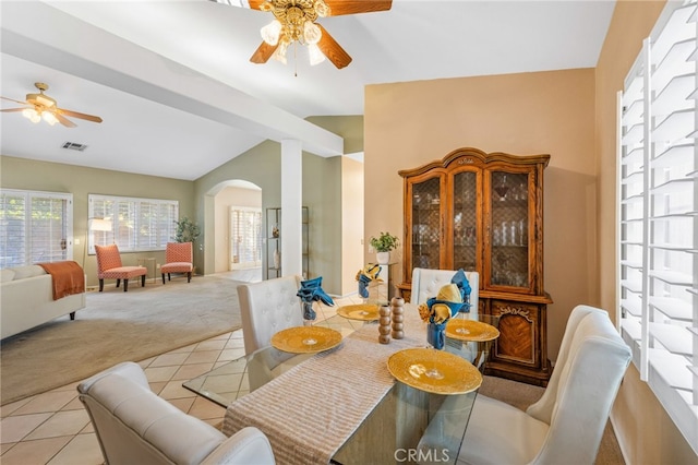 carpeted dining room featuring ceiling fan and vaulted ceiling