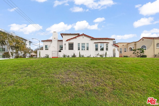 rear view of property with a yard