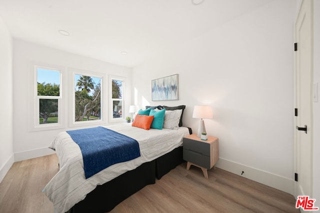 bedroom with light wood-type flooring