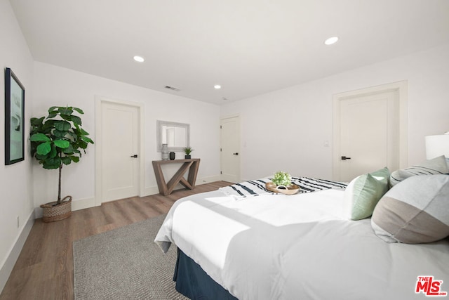 bedroom with dark hardwood / wood-style flooring