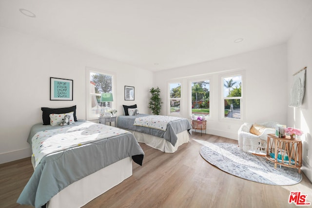 bedroom featuring light hardwood / wood-style floors and multiple windows