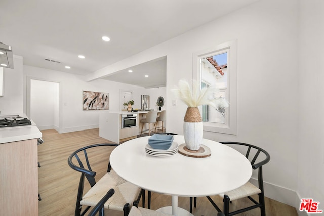 dining space featuring light hardwood / wood-style flooring