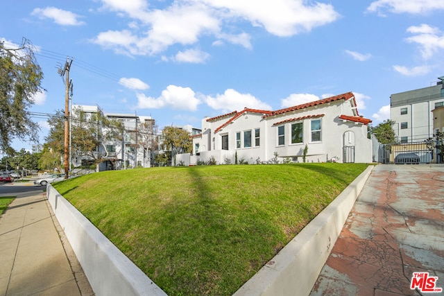 mediterranean / spanish-style home featuring a front yard