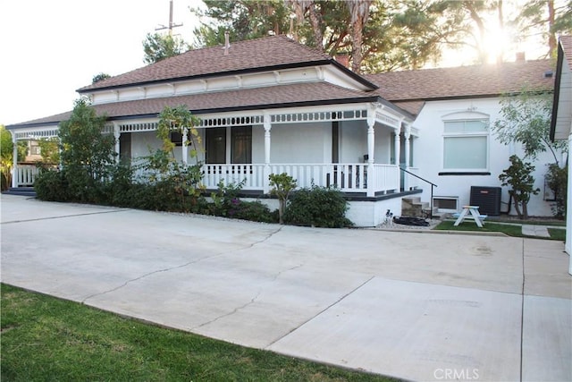 view of front of property with a porch and central AC