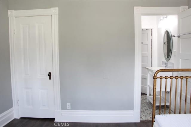 unfurnished bedroom with dark hardwood / wood-style flooring