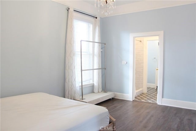 bedroom featuring dark wood-type flooring and an inviting chandelier