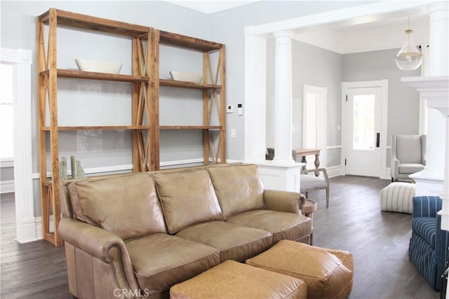 living room with dark wood-type flooring and decorative columns