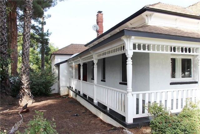 view of side of home with a porch