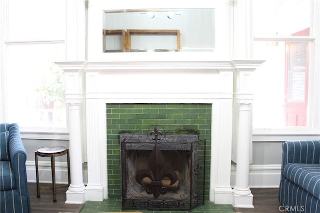 details with wood-type flooring and a tile fireplace