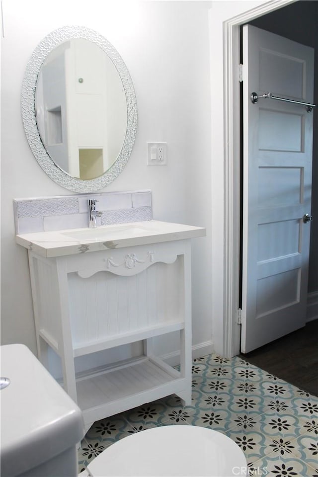 bathroom with vanity, hardwood / wood-style flooring, and toilet