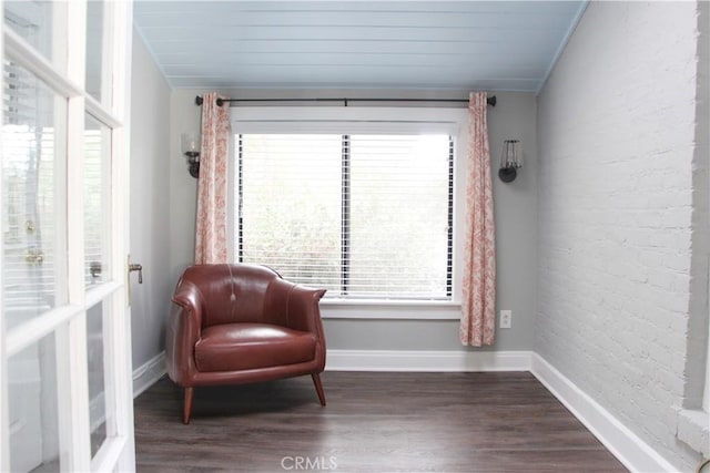 sitting room with dark hardwood / wood-style flooring, crown molding, plenty of natural light, and vaulted ceiling