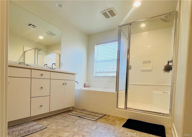 bathroom featuring vanity and shower with separate bathtub