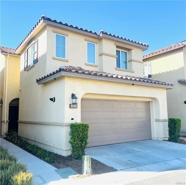 mediterranean / spanish house featuring a garage