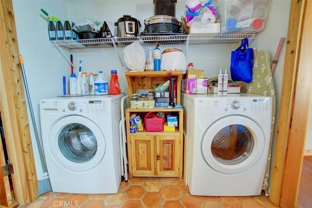 clothes washing area featuring washer / dryer and light tile patterned flooring