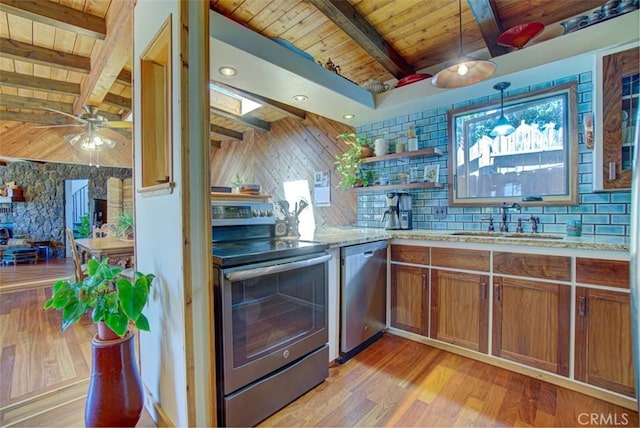 kitchen featuring beamed ceiling, appliances with stainless steel finishes, light wood-type flooring, and wood ceiling