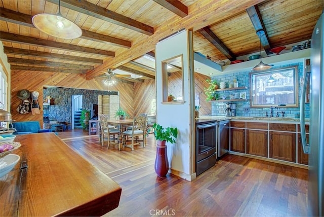 kitchen featuring appliances with stainless steel finishes, ceiling fan, dark hardwood / wood-style flooring, and wooden walls