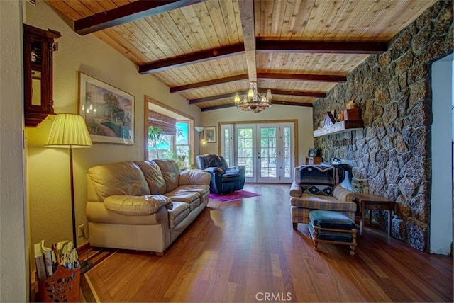 living room featuring french doors, wooden ceiling, lofted ceiling with beams, hardwood / wood-style floors, and a chandelier