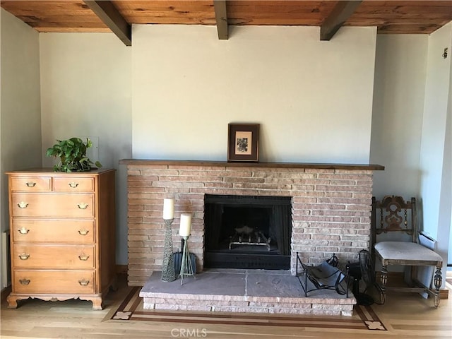 interior details with a fireplace, beam ceiling, hardwood / wood-style flooring, and wood ceiling