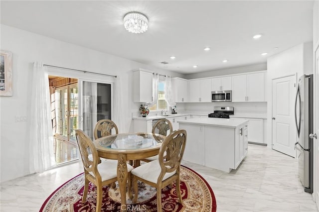 dining space featuring plenty of natural light and an inviting chandelier