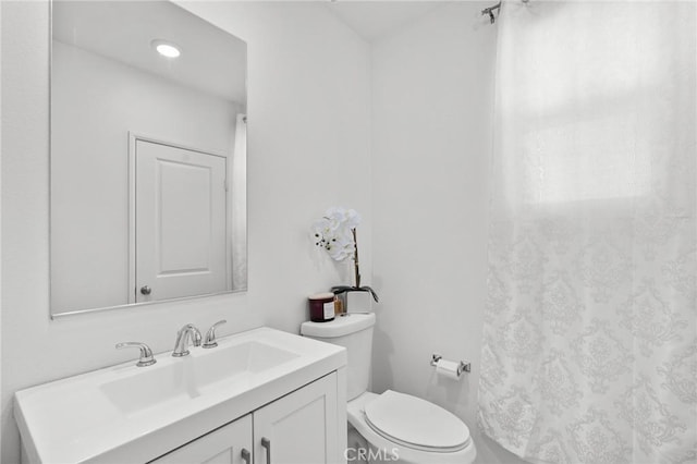 bathroom featuring vanity and toilet