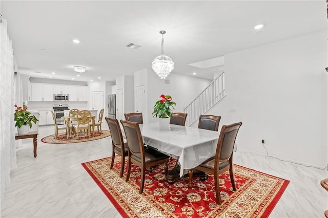 dining space featuring a notable chandelier