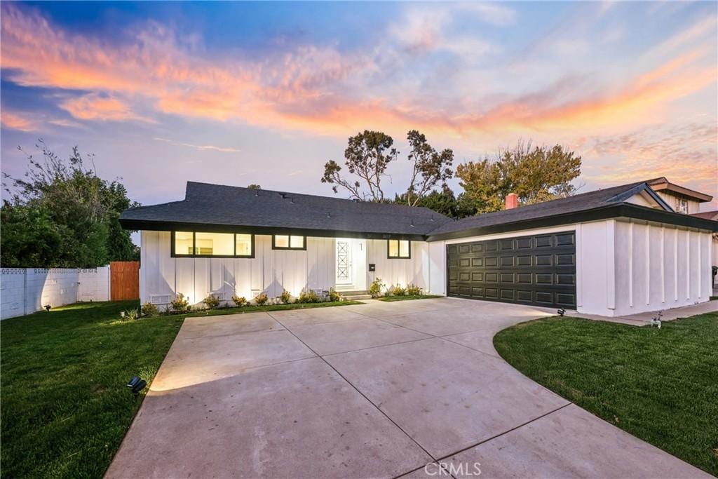 view of front of house with a garage and a yard