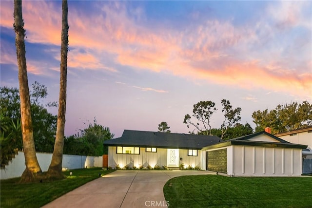 view of front facade with a yard and a garage